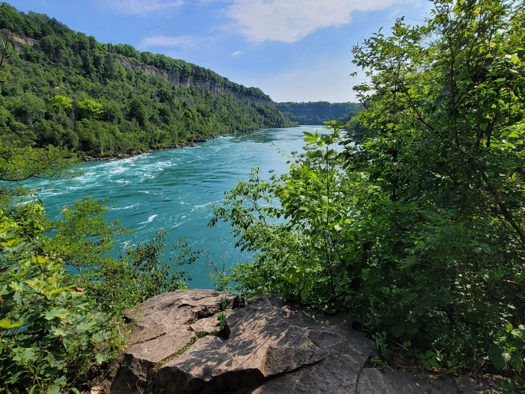 Turquoise rapids rushing through the Niagara River Gorge, one of the best places to visit in April.