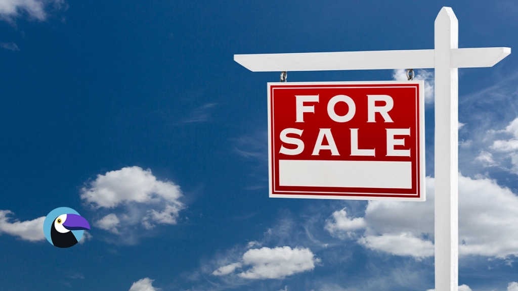Red real estate for sale sign against a blue sky with clouds, illustrating how to advertise a timeshare for sale.