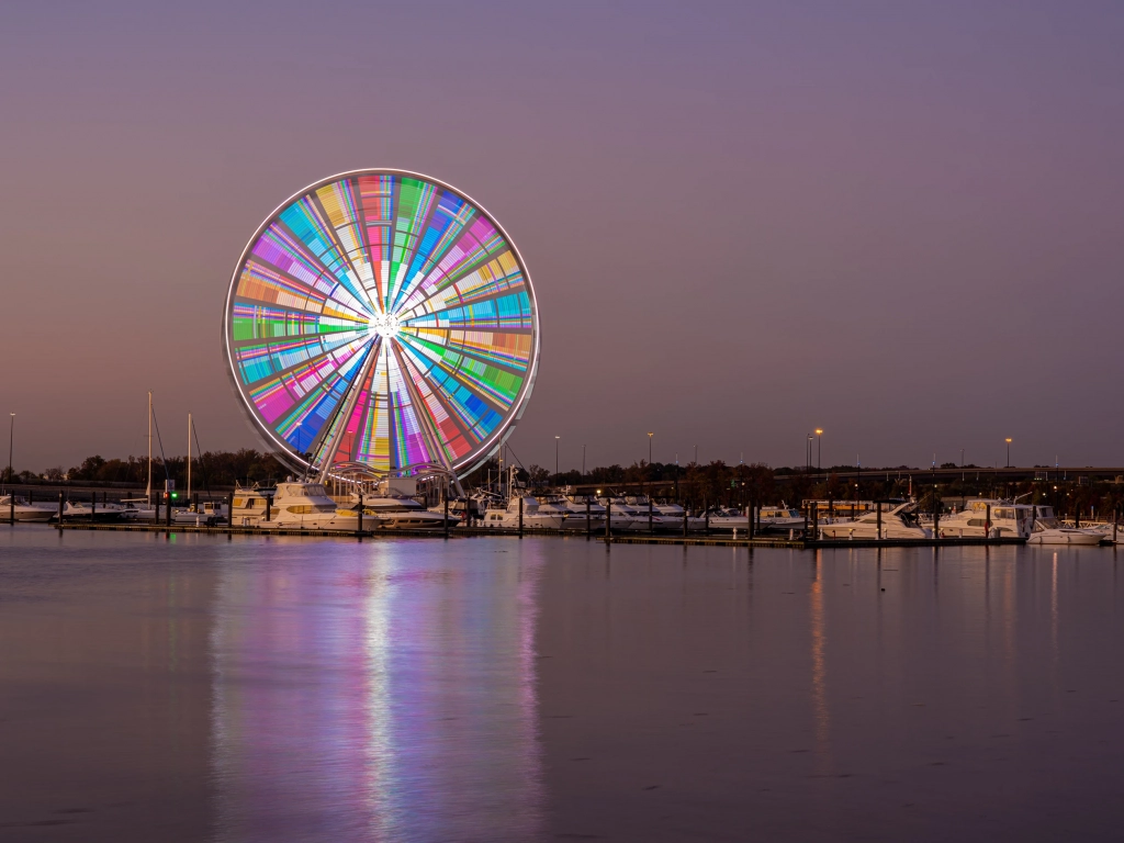 The Capital Wheel at National Harbor, Maryland, one of the best places to visit in April, illuminated at twilight.