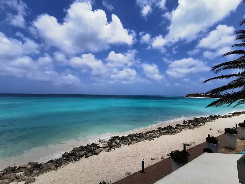 High-angle view of the vibrant turquoise Caribbean Sea and rocky white sand shoreline at Divi Dutch Village Beach Resort.

How does Divi Resorts timeshare work?