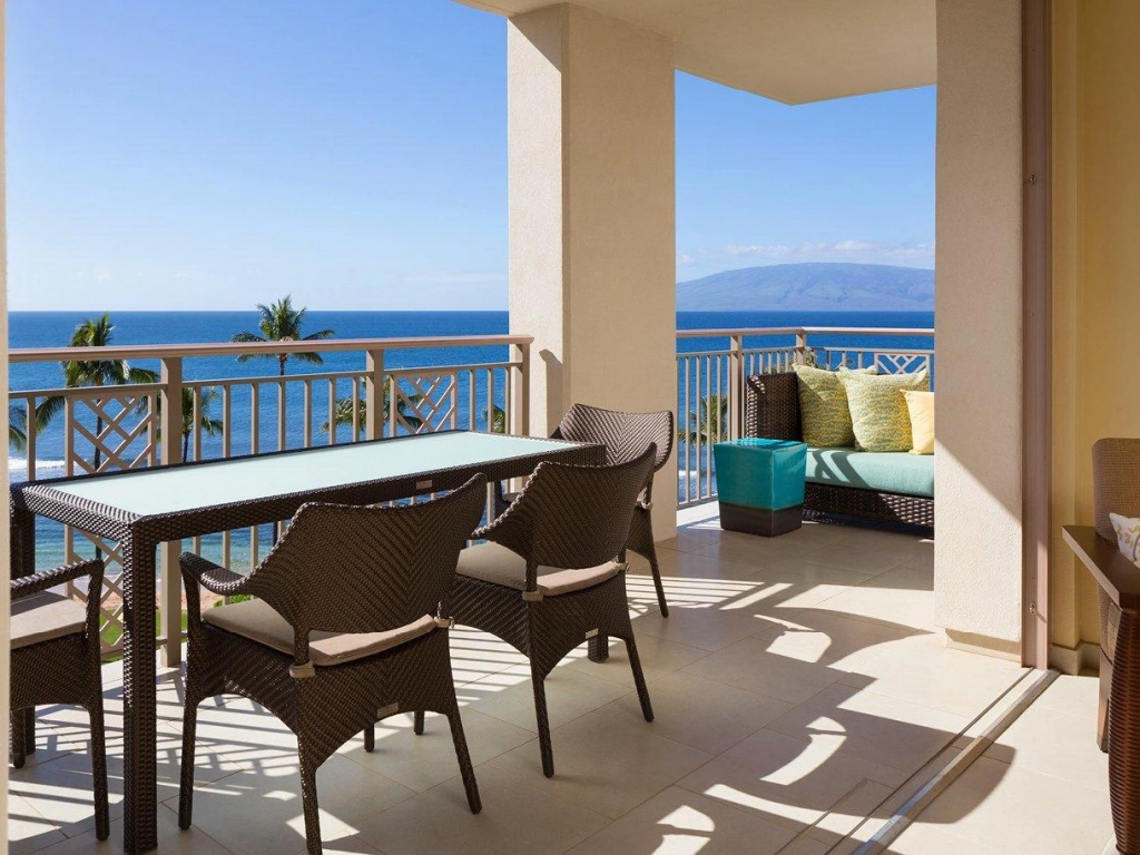 Oceanfront balcony view at Hyatt Residence Club Maui, Kāʻanapali Beach with patio furniture and sweeping ocean views, offering a serene setting. Difference Between Points and Weeks Timeshare