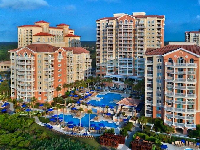 Aerial view of a Marriott's Oceanwatch with pools and palm trees. - Summer Vacation Ideas