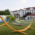 Wooden hammocks on a lawn at The Suites at Hershey, a property often highlighted in bluegreen vacations reviews.