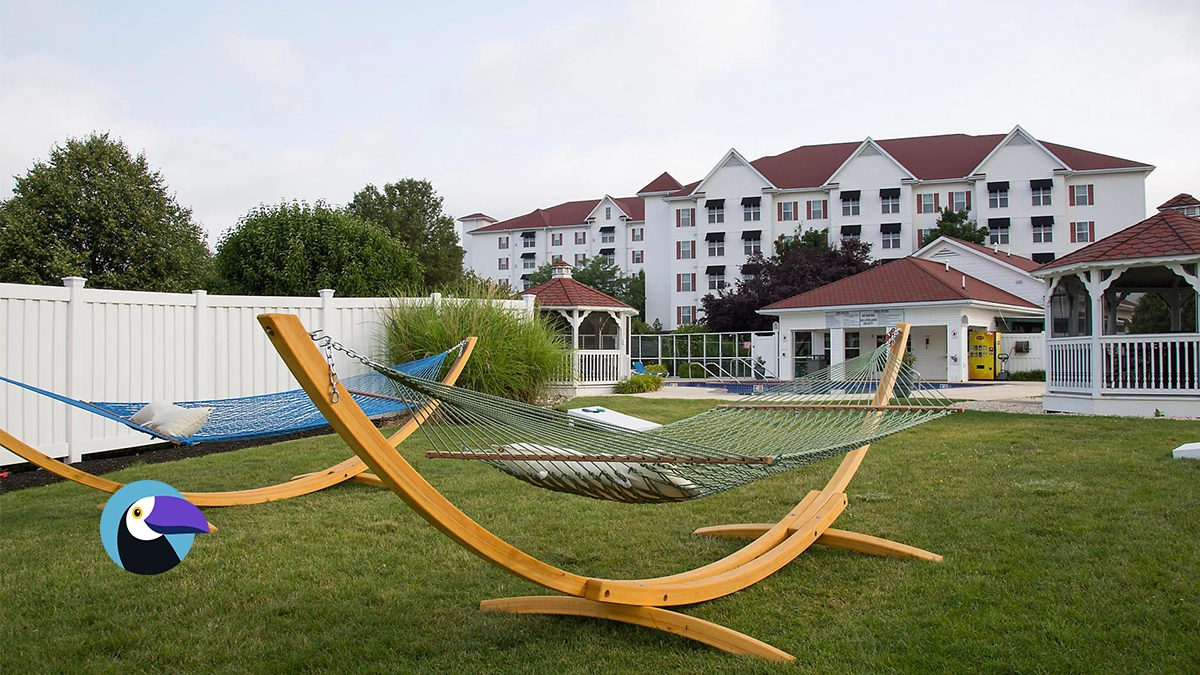 Wooden hammocks on a lawn at The Suites at Hershey, a property often highlighted in bluegreen vacations reviews.
