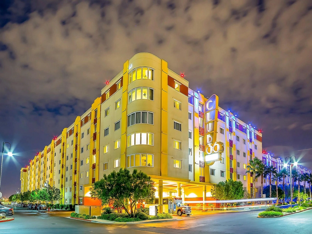 Exterior of Club 36 resort at night, a popular destination highlighted in bluegreen vacations reviews.