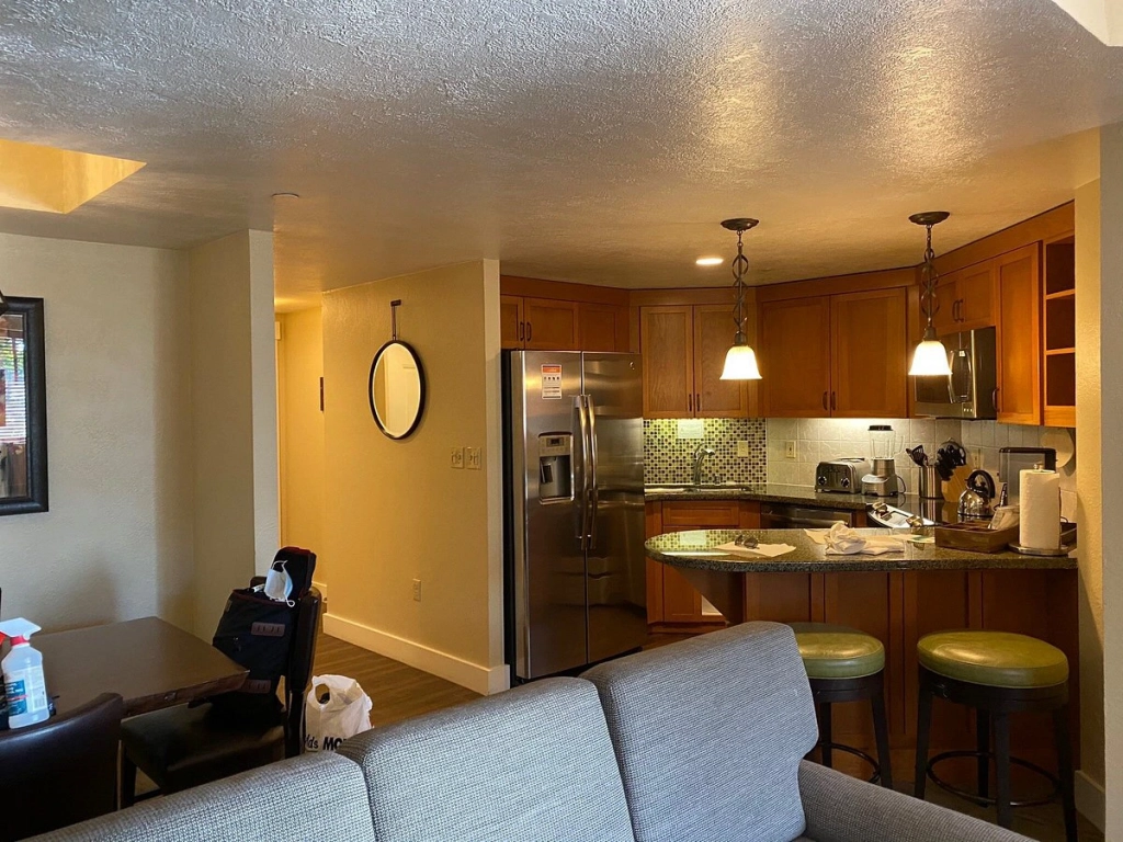 Modern resort suite kitchen with stainless steel appliances and wood cabinetry at Marriott Grand Residences.
