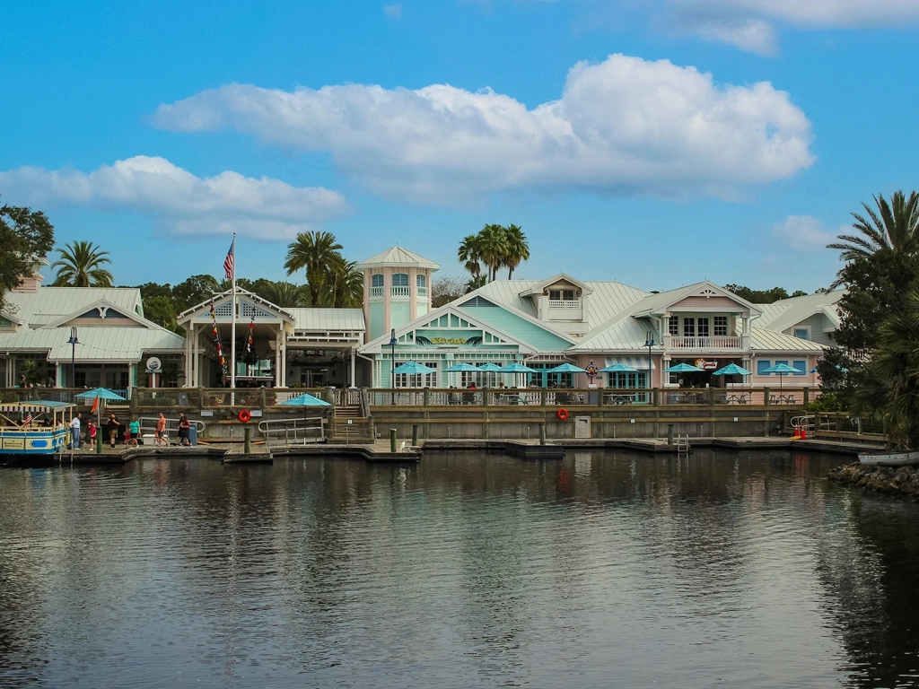 Pastel waterfront buildings and the marina at Disney's Old Key West Resort, featuring Olivia's Cafe