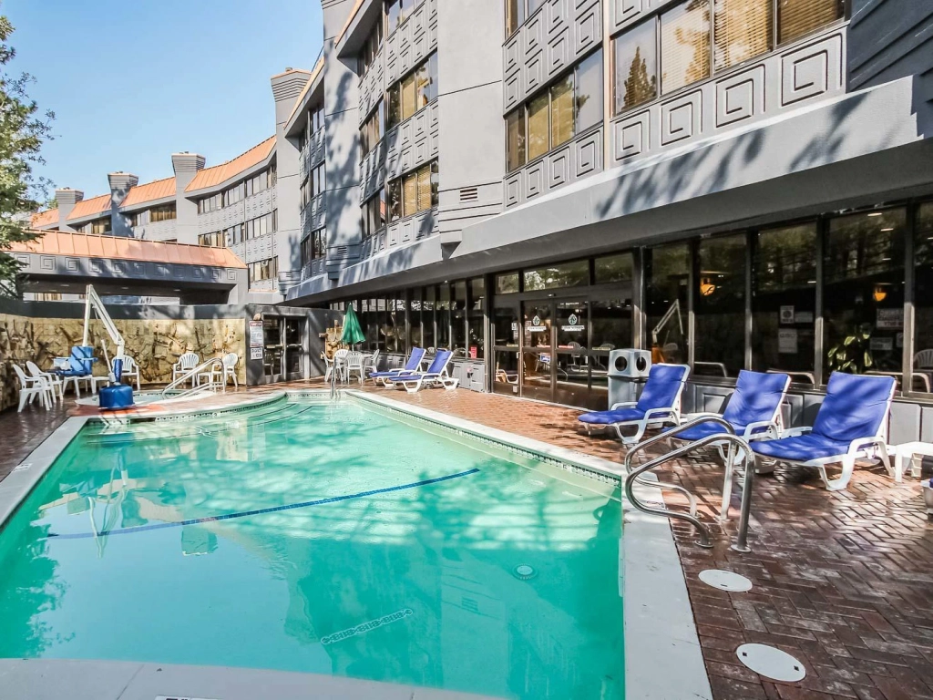 The outdoor pool and patio area of the Tahoe Seasons Resort under a clear blue sky.