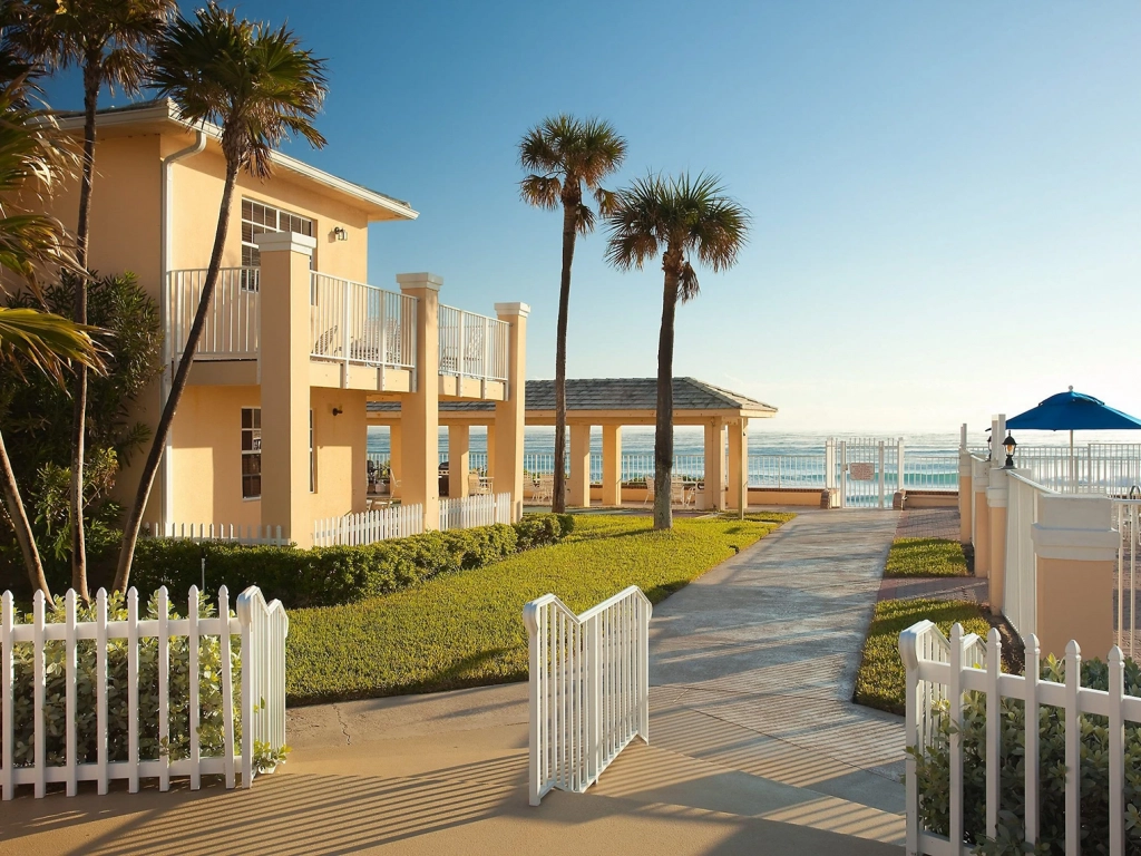 Sunny beach path next to Gulfstream Manor, a coastal resort noted in bluegreen vacations reviews.