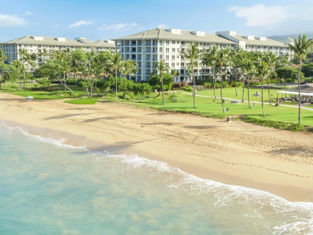 Grand resort building surrounded by lush lawns and mountains, highlighting westin vacation club benefits.