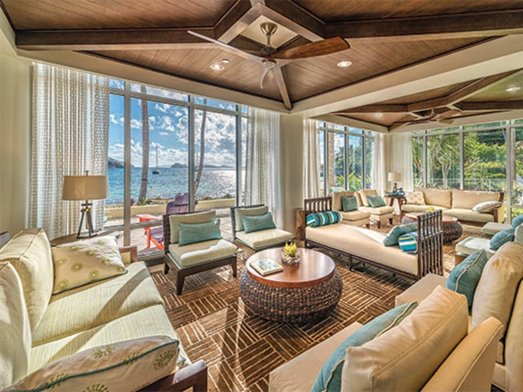 Spacious coastal lounge at Margaritaville St. Thomas featuring woven furniture and large ocean-view windows.