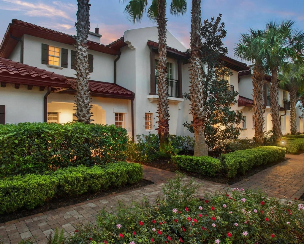 Lit pathway and red tile roofs at Marriott's Lakeshore Reserve at dusk.
