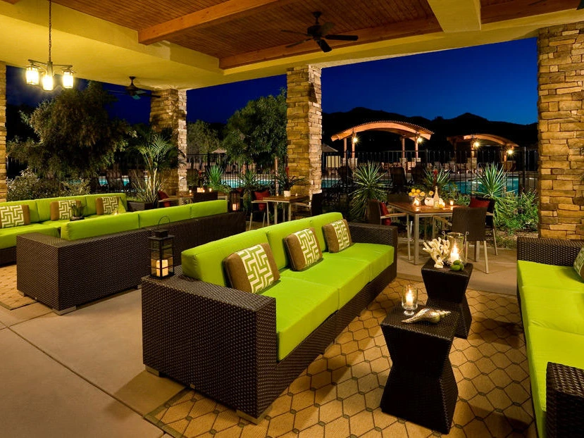 Outdoor lounge area with lime green cushions at night at Villas on the Greens by Welk Resorts.