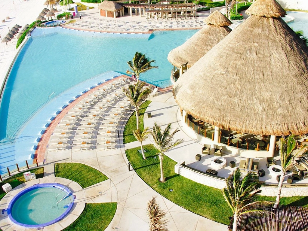 High-angle view of a large thatched-roof building beside a swimming pool and hot tub at The Westin Lagunamar.
