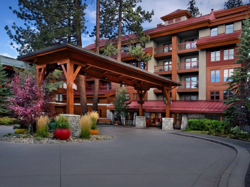 Rustic lodge exterior, wood beams, and pine trees at Marriott Grand Residences Tahoe.