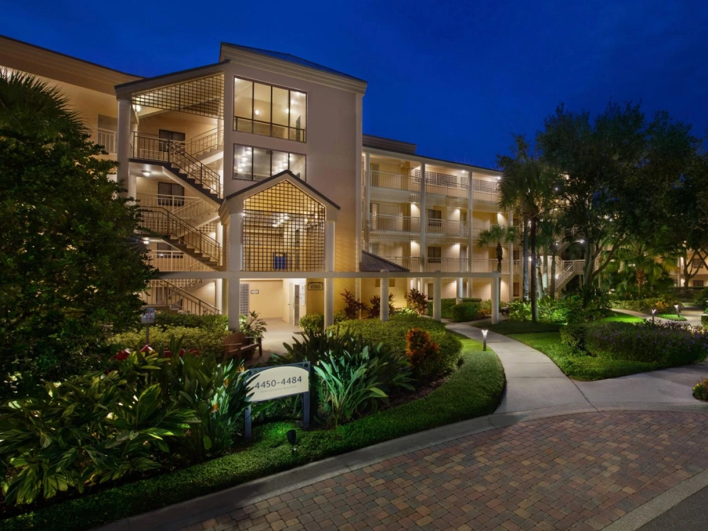 Illuminated exterior and landscaped walkway at Marriott's Royal Palms. Ask how does Marriott timeshare work here.